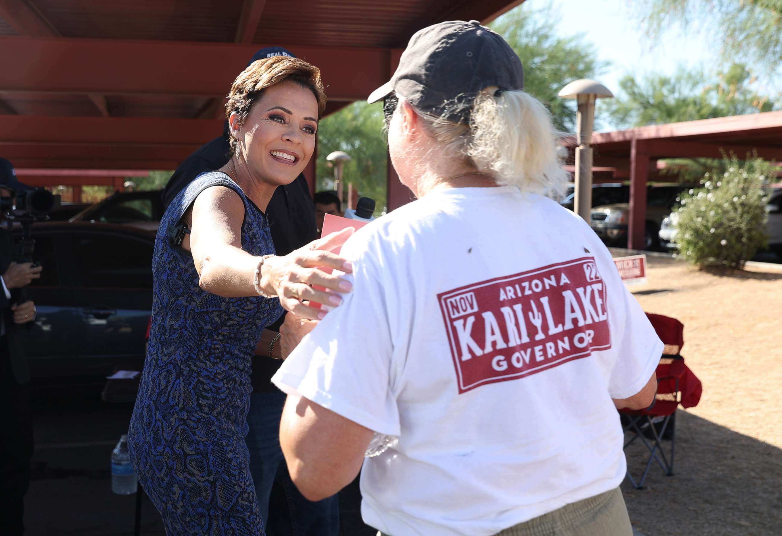 PHOTO: Republican candidate for Arizona Governor Kari Lake greets a supporter outside of a polling place before voting in the primary in Paradise Valley, Ariz., Aug. 2, 2022.