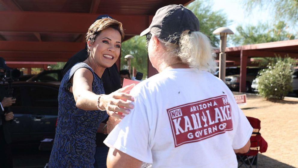 PHOTO: Republican candidate for Arizona Governor Kari Lake greets a supporter outside of a polling place before voting in the primary in Paradise Valley, Ariz., Aug. 2, 2022.