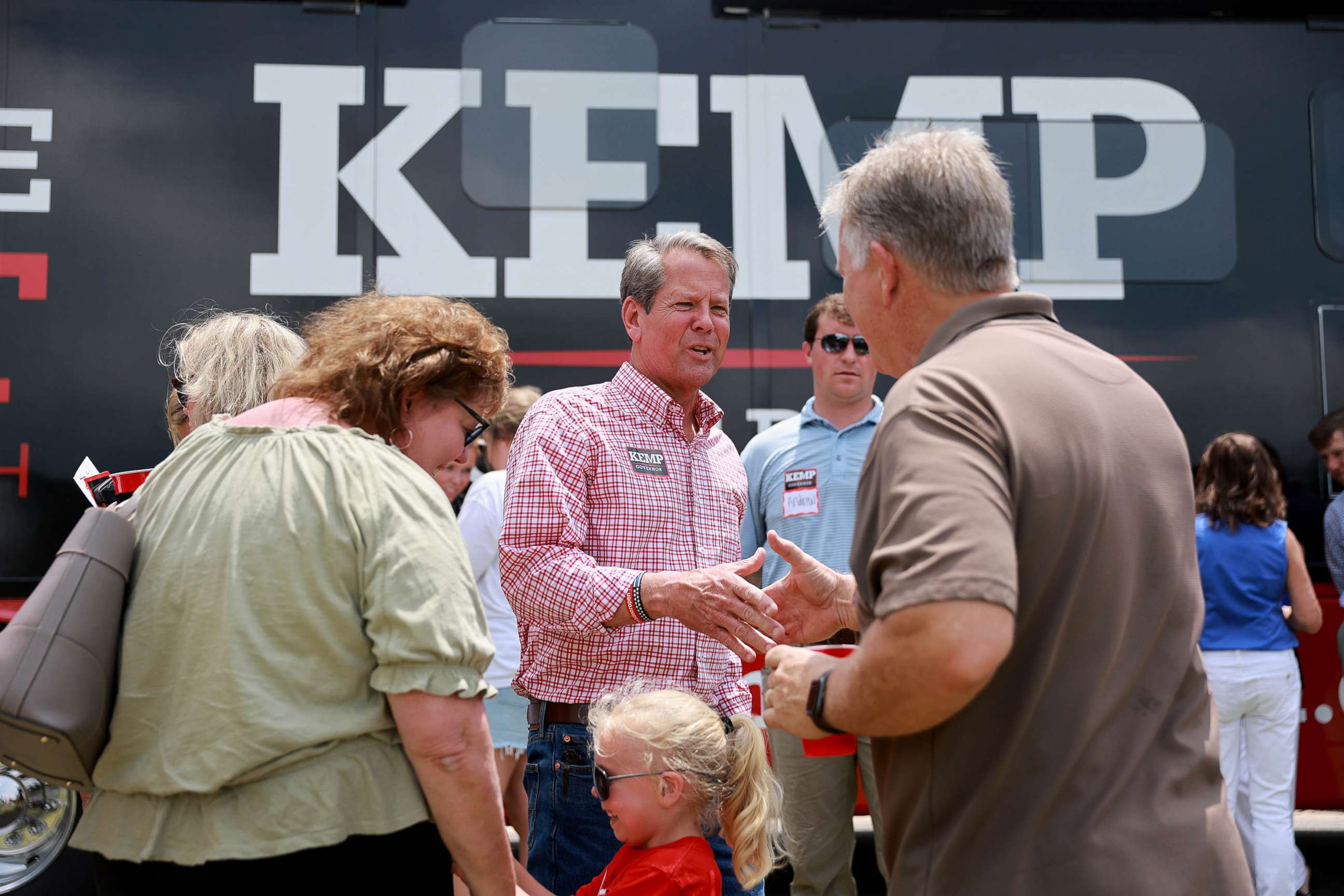 PHOTO: Georgia Gov. Brian Kemp greets people as he campaigns during a Get Out the Vote cookout at the Hadden in Watkinsville, Ga., May 21, 2022.