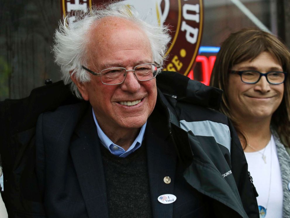 PHOTO: Sen. Bernie Sanders smiles as he poses for a photograph with Vermont Democratic gubernatorial candidate Christine Hallquist outside City Hall in Saint Albans, Vt., Nov. 6, 2018.