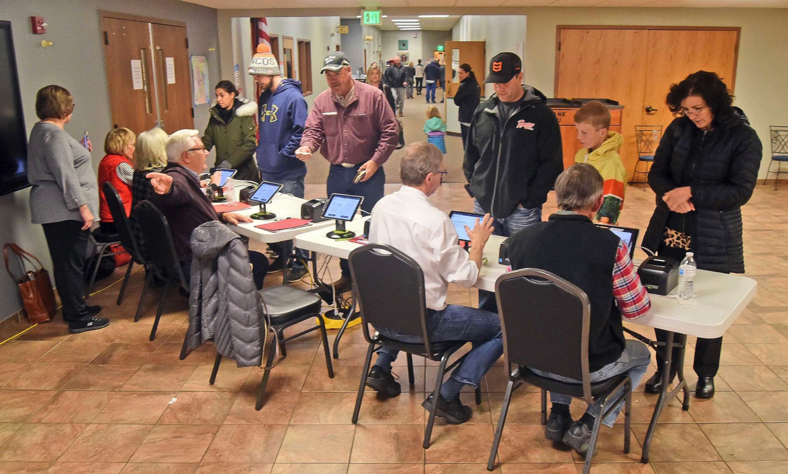 PHOTO: Election workers check identification of each person before receiving a ballot at the northwest Bismarck, N.D., polling place in Century Baptist Church on Tuesday, Nov. 6, 2018.