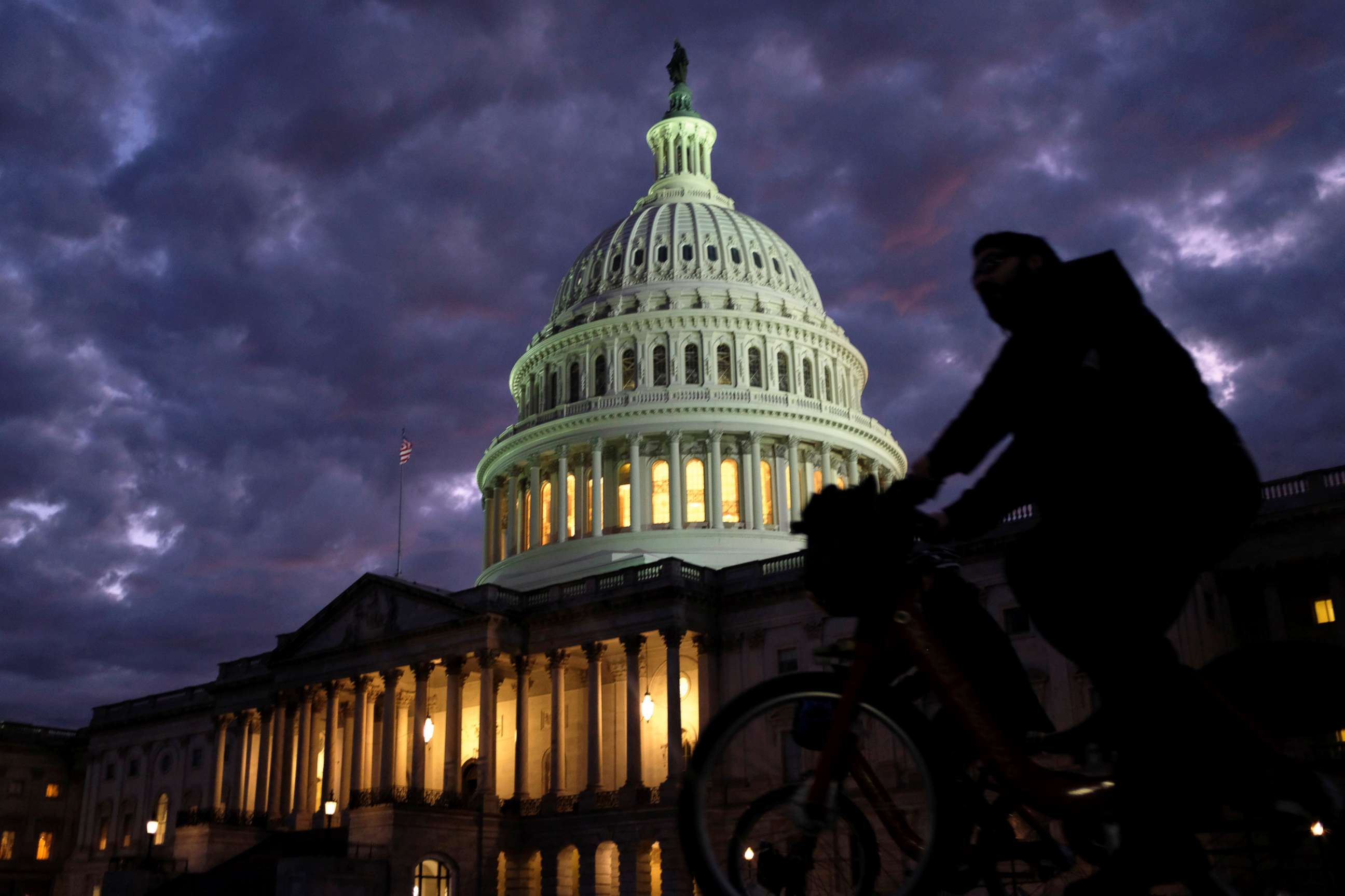 PHOTO: Cyclists ride past the U.S. Capitol dome in Washington on midterm election day, Nov. 6, 2018.