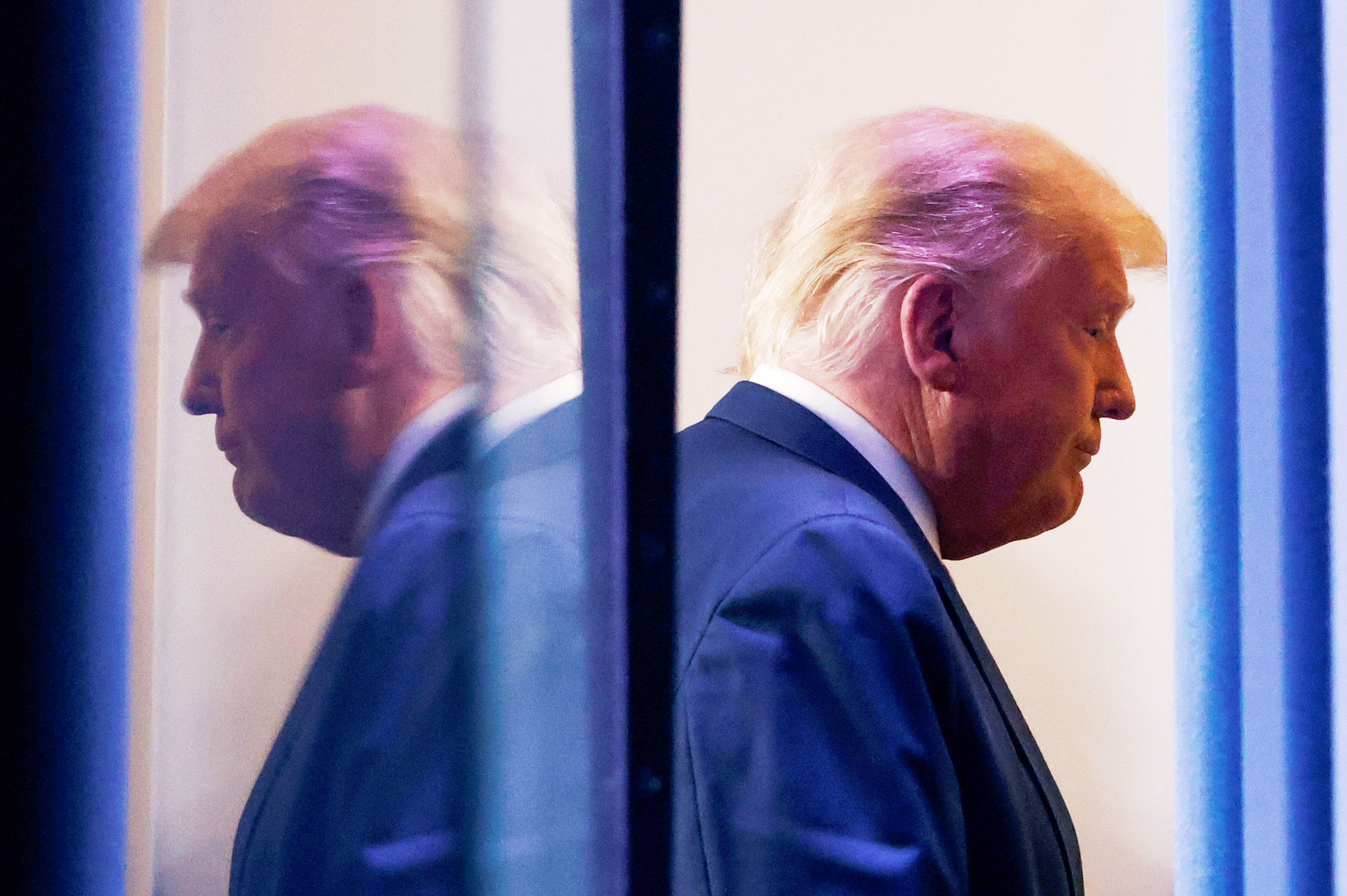 PHOTO: President Donald Trump is reflected as he departs after speaking about the 2020 U.S. presidential election results in the Brady Press Briefing Room at the White House, Nov. 5, 2020.