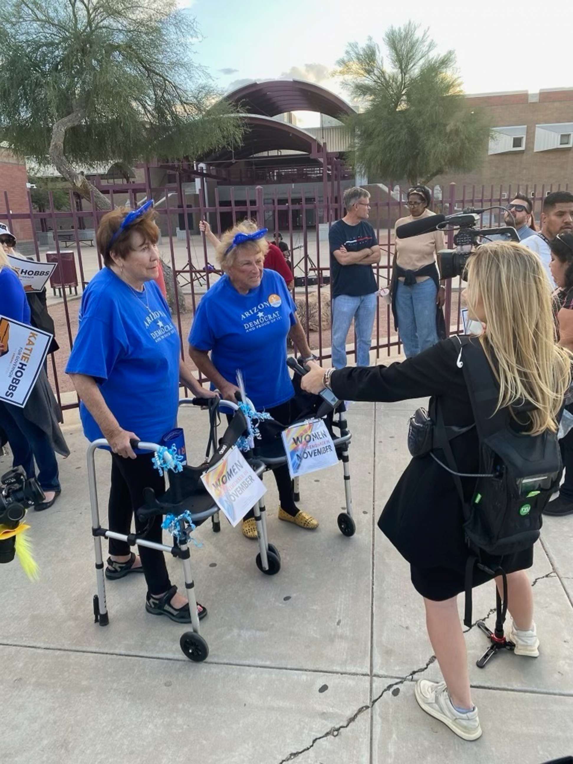 PHOTO: Reporter Libby Cathey of ABC News speaks to voters outside a rally for Democratic candidates with Barak Obama in South Phoenix, Ariz., Nov. 2, 2022.