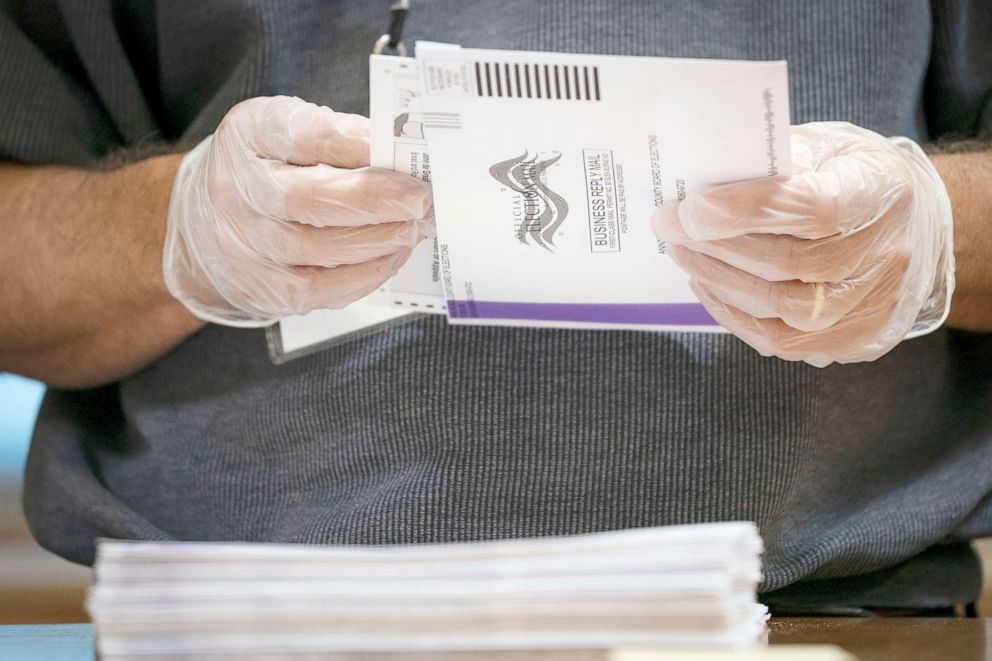 PHOTO:  A canvasser wears gloves while processing mail-in ballots in a warehouse in Glen Burnie, Md., Oct. 7, 2020. 