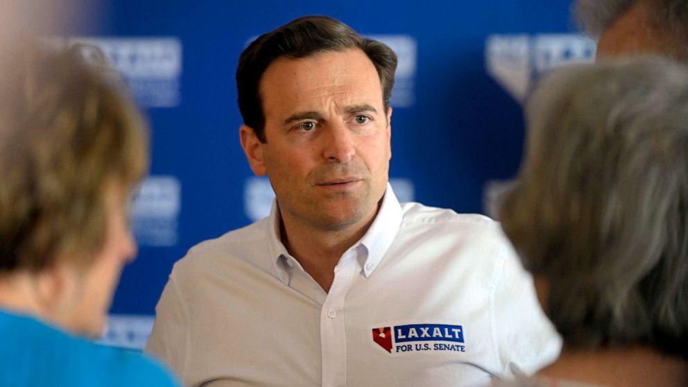PHOTO: Nevada Senate candidate Adam Laxalt speaks with people during a campaign event in Logandale, Nev., June 11, 2022.