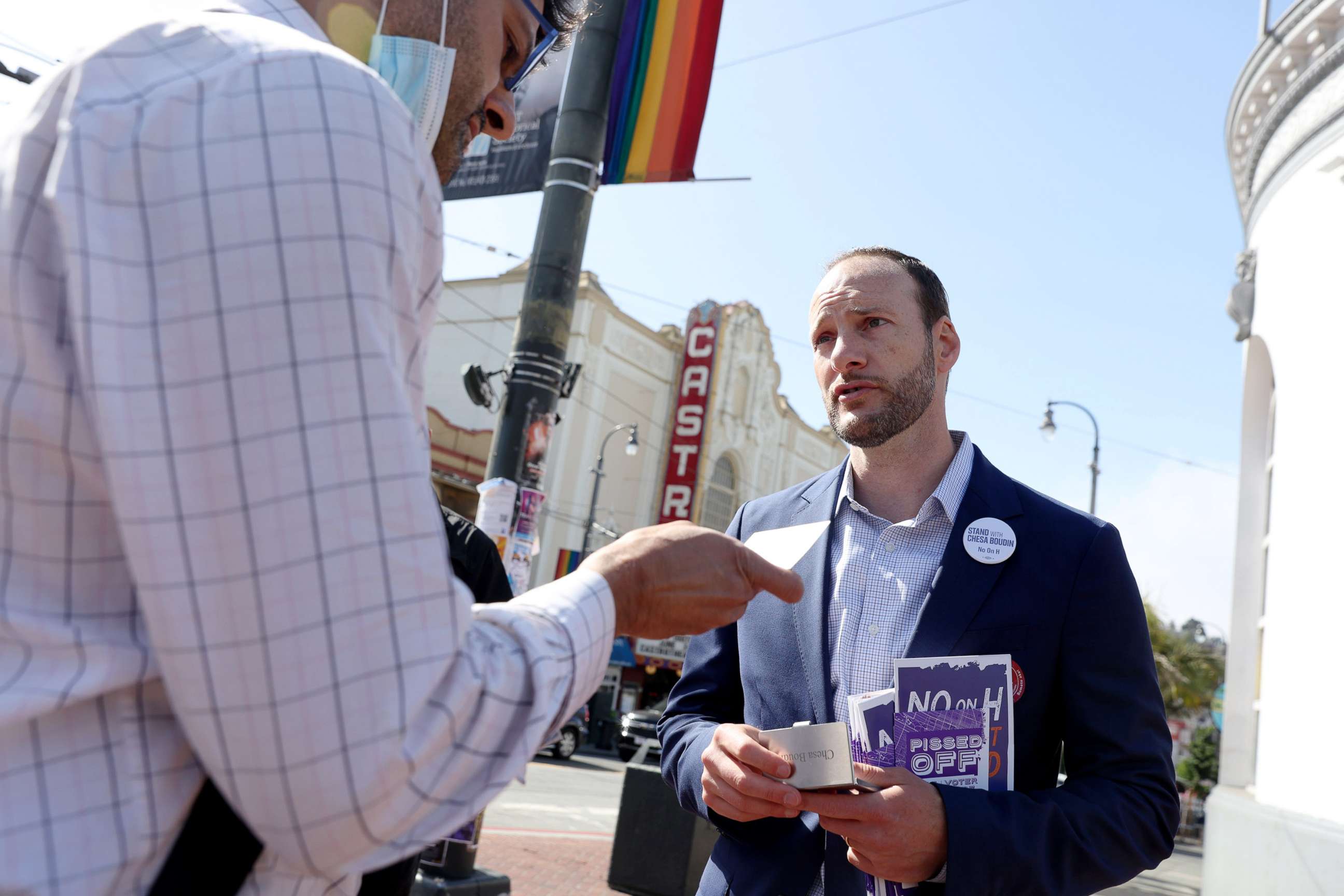 PHOTO: District Attorney Chesa Boudin greets potential voters outside of the Castro Street MUNI station in San Francisco, Calif., June 7, 2022.