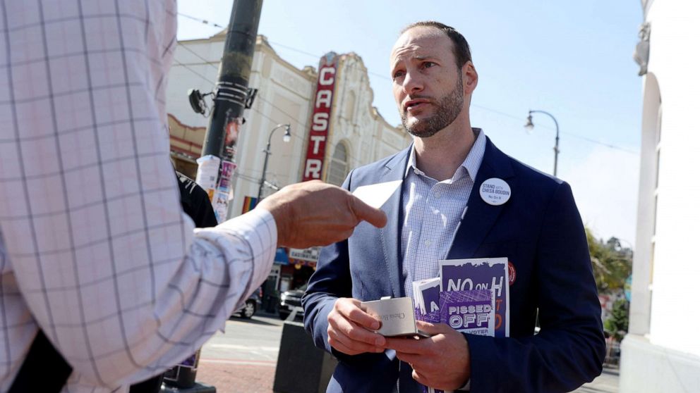 PHOTO: District Attorney Chesa Boudin greets potential voters outside of the Castro Street MUNI station in San Francisco, Calif., June 7, 2022.