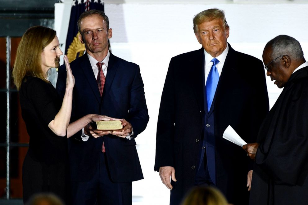 PHOTO: President Donald Trump watches as Supreme Court Associate Justice Clarence Thomas swears in Judge Amy Coney Barrett as a US Supreme Court Associate Justice during a ceremony on the South Lawn of the White House Oct. 26, 2020.