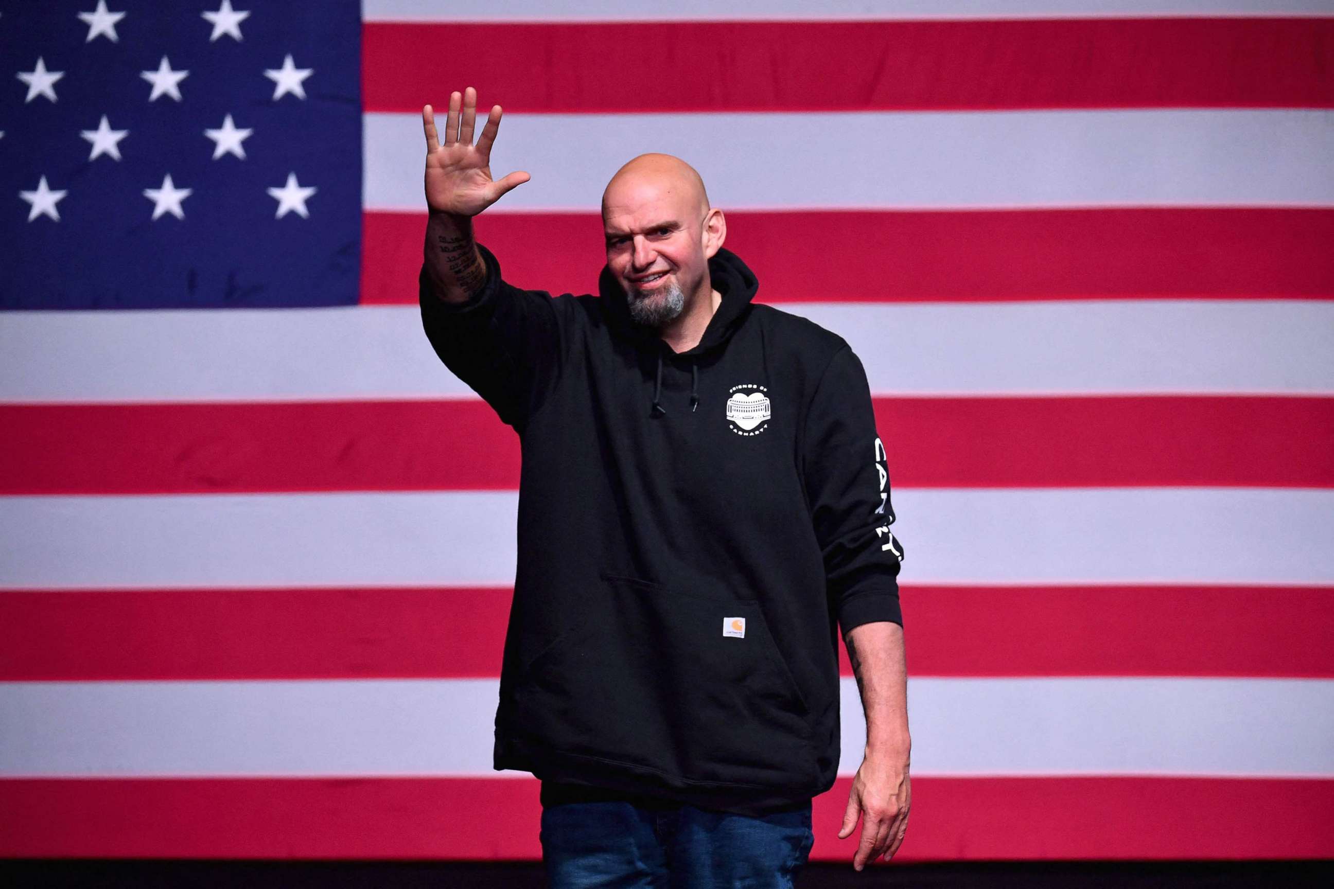 PHOTO: Pennsylvania Democratic Senatorial candidate John Fetterman waves onstage at a watch party during the midterm elections at Stage AE in Pittsburgh, PA, on Nov 8, 2022.