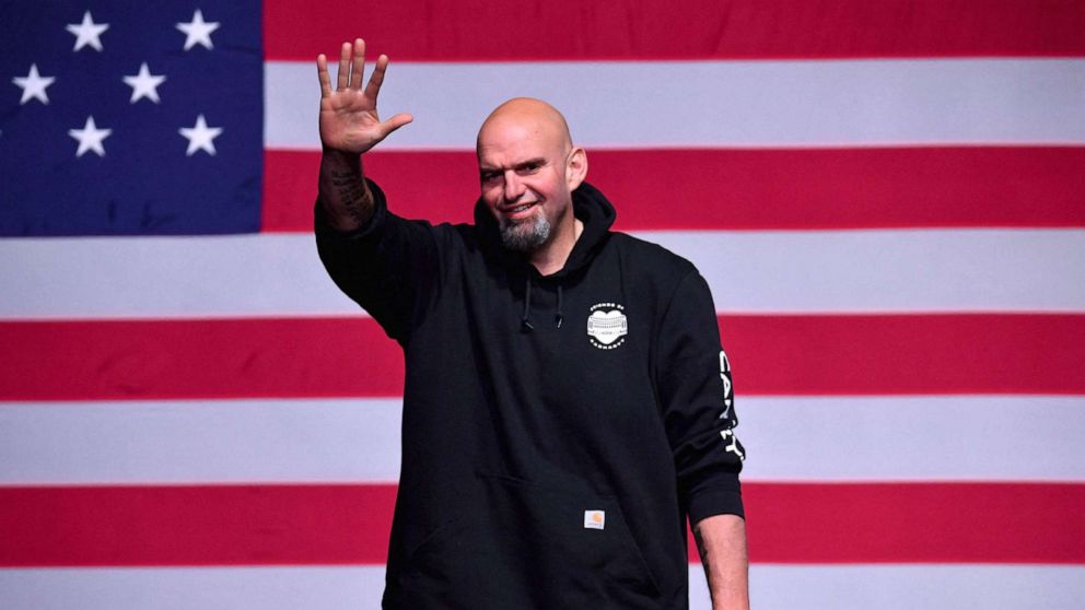PHOTO: Pennsylvania Democratic Senatorial candidate John Fetterman waves onstage at a watch party during the midterm elections at Stage AE in Pittsburgh, PA, on Nov 8, 2022.