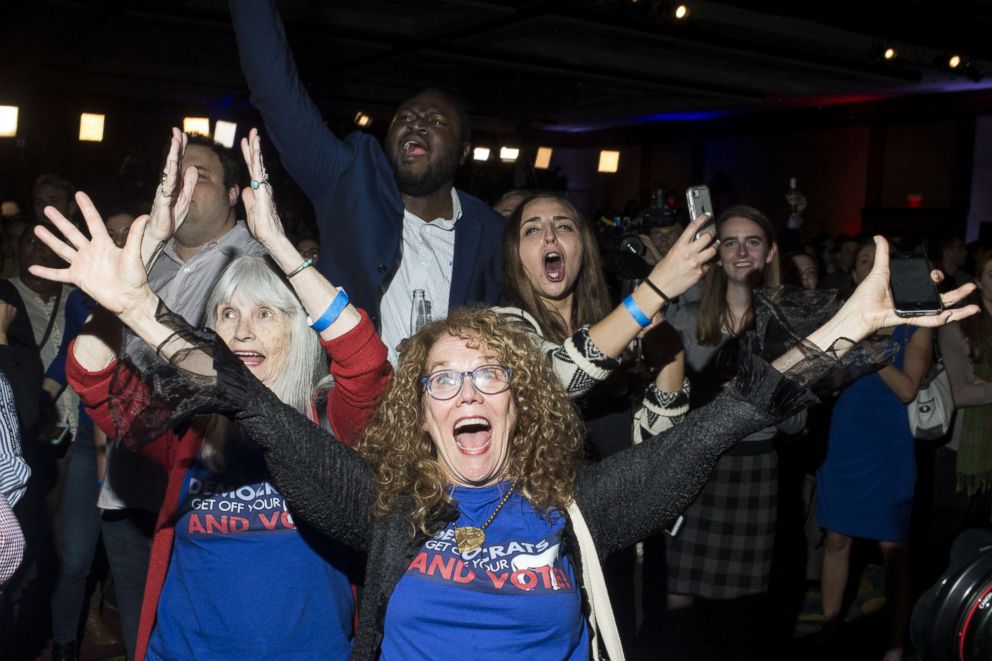 PHOTO: JoAnn Loulan, center, reacts with her mother-in-law, Sydney Crawford, left, after Democrats gained control of the House of Representatives during the 2018 midterm election at a DCCC election watch party, Nov. 6, 2018, in Washington, D.C.