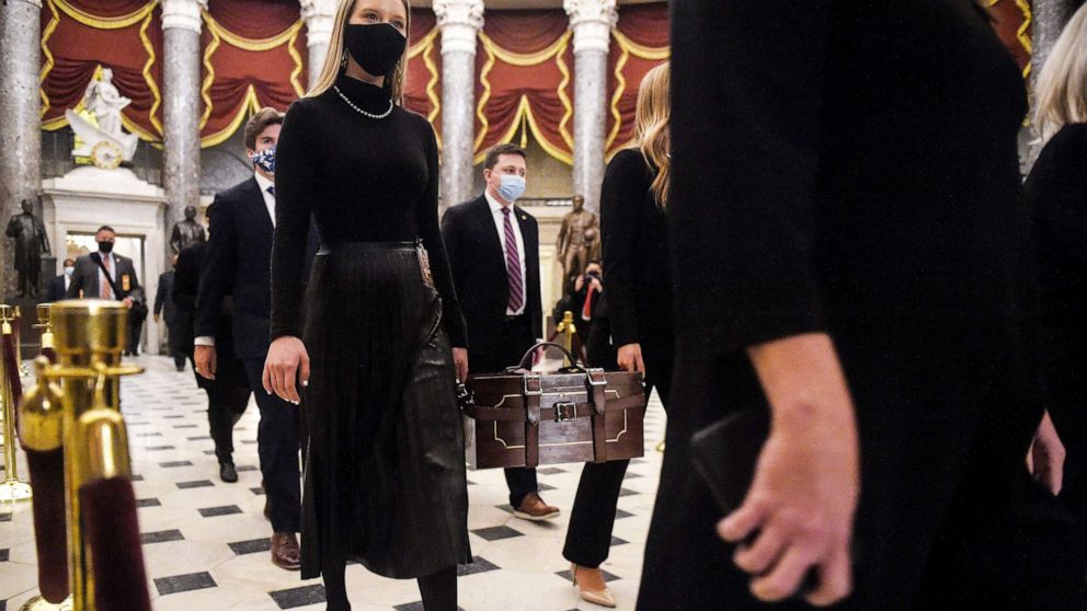 PHOTO: Senate pages carry the Electoral College ballot boxes on Jan. 7, 2021 at the Capitol, in Washington after President Trump's supporters stormed the building.