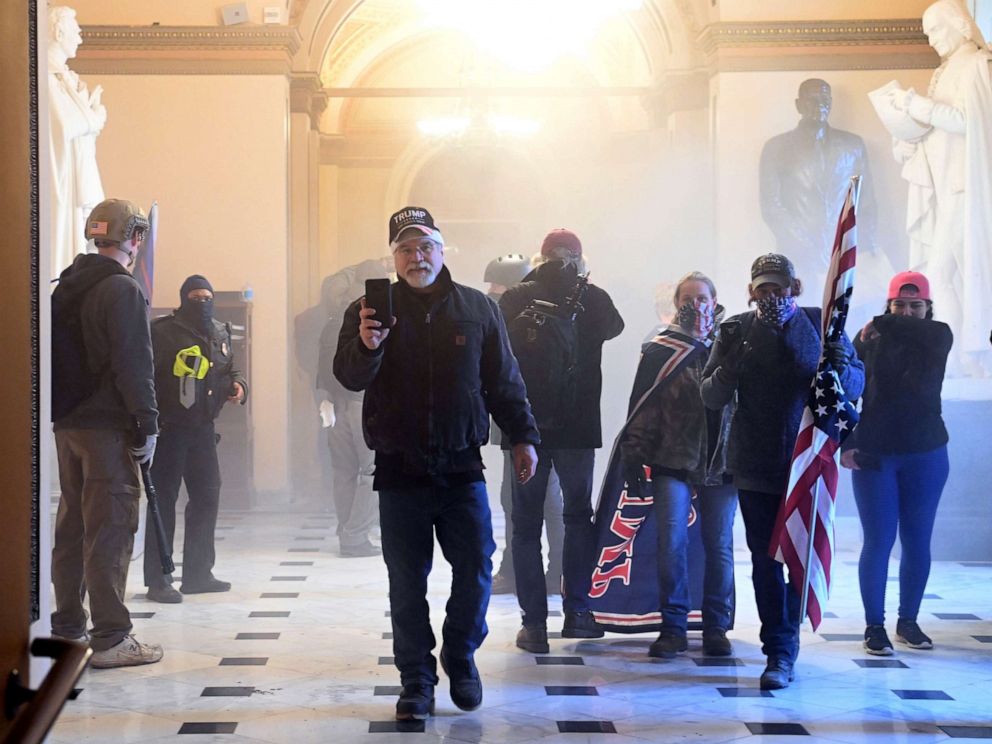 PHOTO: Supporters of President Donald Trump enter the US Capitol as tear gas fills the corridor, Jan. 6, 2021, in Washington, DC.