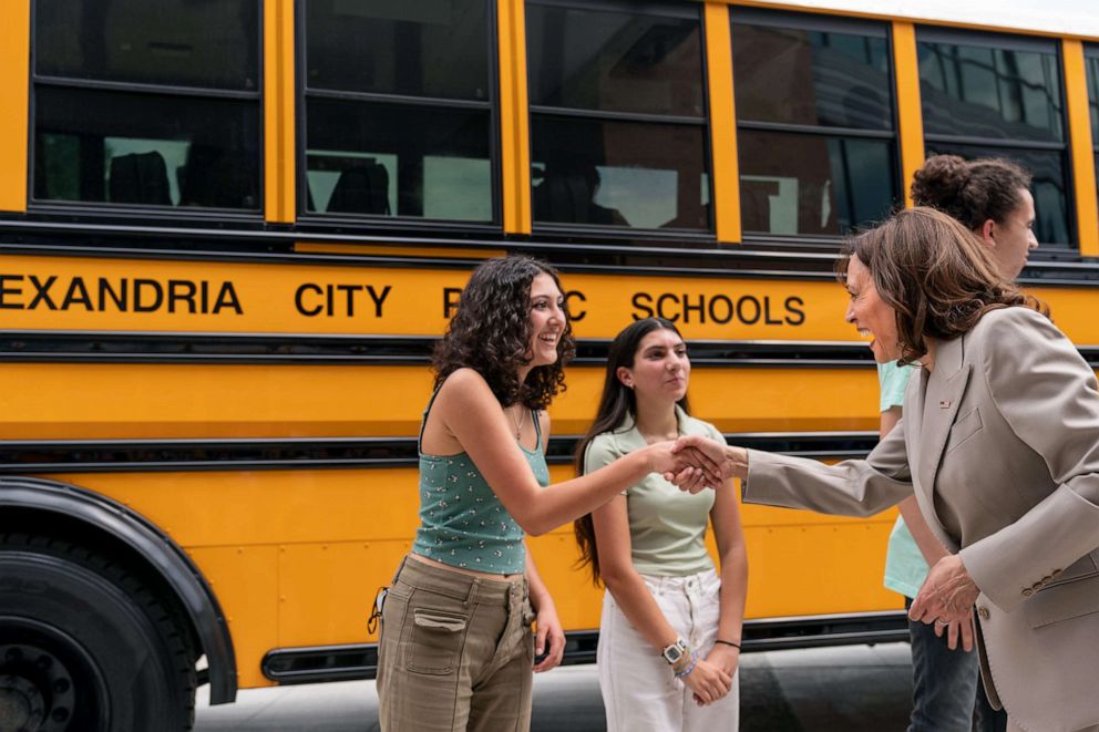 PHOTO: Vice President Kamala Harris greets student environmental leaders as she tours electric school buses during an event at Meridian High School in Falls Church, Virginia on May 20, 2022.