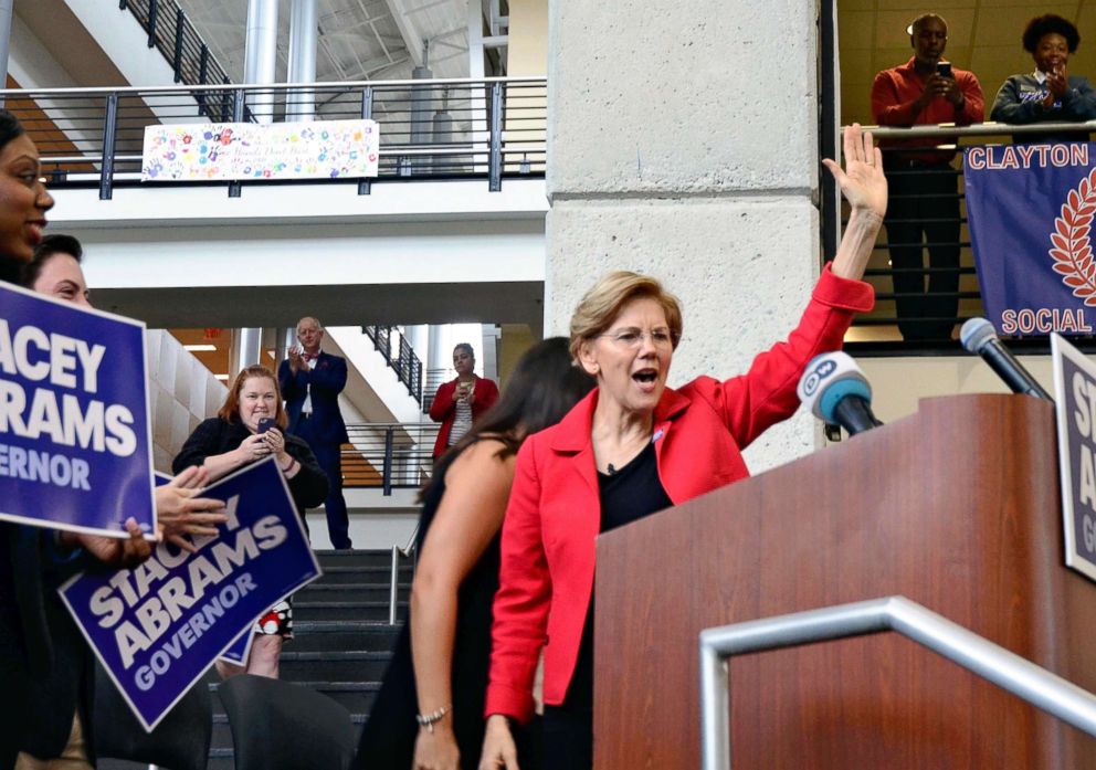 PHOTO: Elizabeth Warren, Senator from Massachusetts, raises her hand during a meeting of Georgian gubernatorial election campaign in the suburb of Atlanta, on Oct.9, 2018.