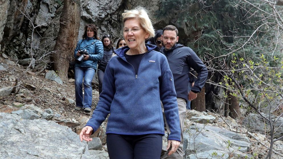 PHOTO: Democratic presidential candidate Sen. Elizabeth Warren, D-Mass., walks with Carl Fisher, of Save Our Canyons, during an visit to Big Cottonwood Canyon Wednesday, April 17, 2019, east of Salt Lake City.