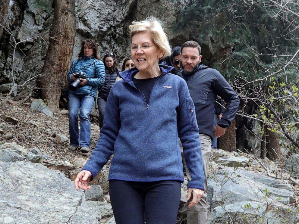 PHOTO: Democratic presidential candidate Sen. Elizabeth Warren, D-Mass., walks with Carl Fisher, of Save Our Canyons, during an visit to Big Cottonwood Canyon Wednesday, April 17, 2019, east of Salt Lake City.