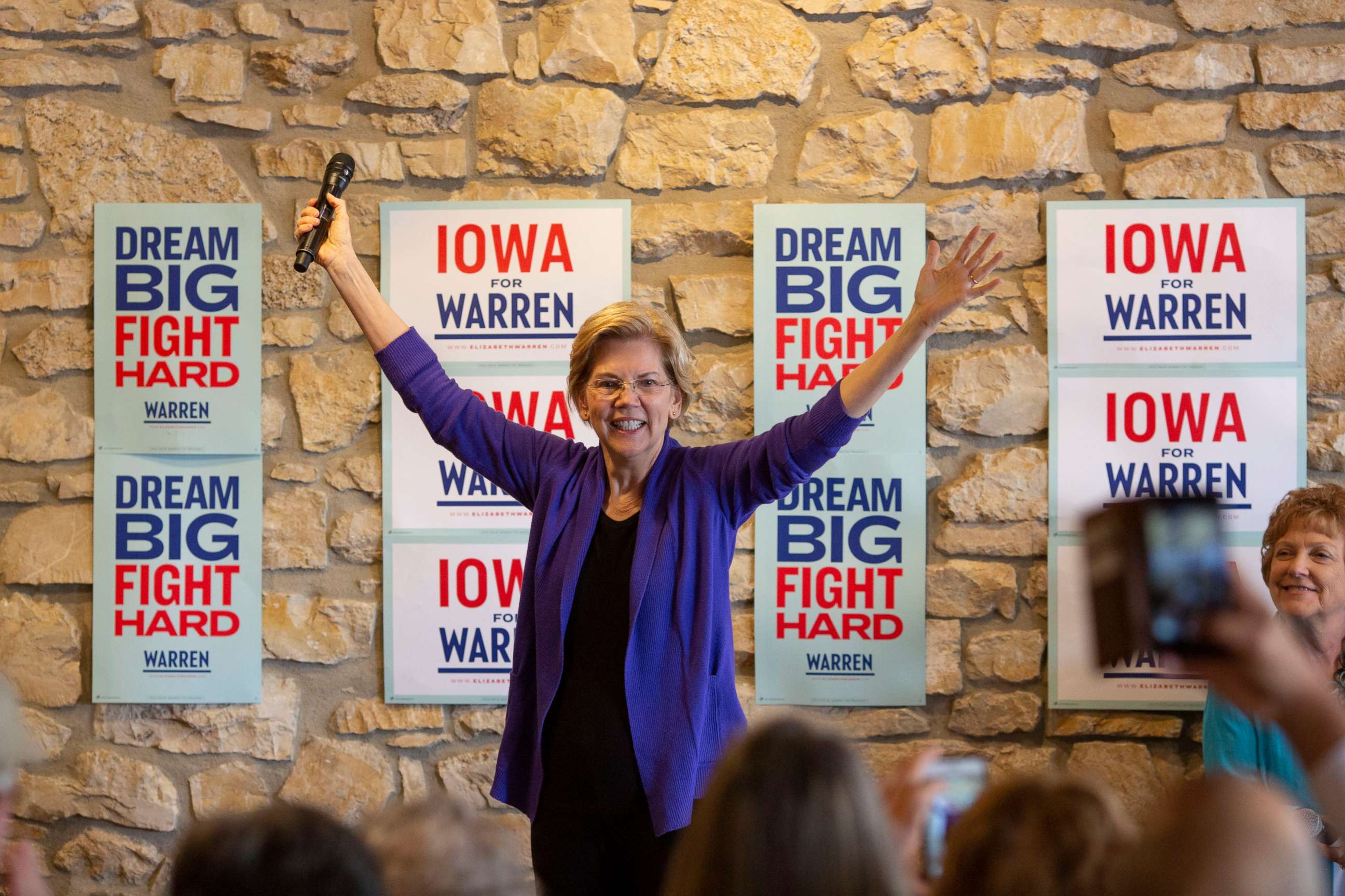 PHOTO: 2020 presidential candidate Sen. Elizabeth Warren acknowledges the crowd as she arrives to speak during a campaign event at Fat Hill Brewing in Mason City, Iowa on May 3, 2019.