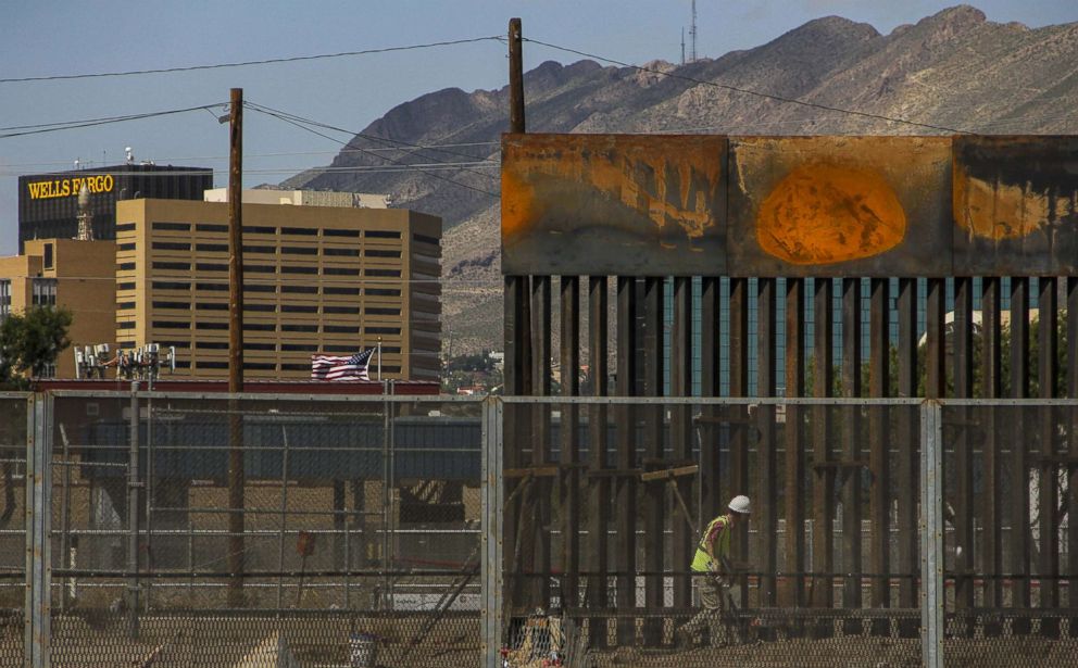 PHOTO: Workers in El Paso, Texas, replace a section of the Mexico-U.S. border fence next to the international border bridge "Paso del Norte" as seen from Ciudad Juarez, Mexico, Sept. 26, 2018.