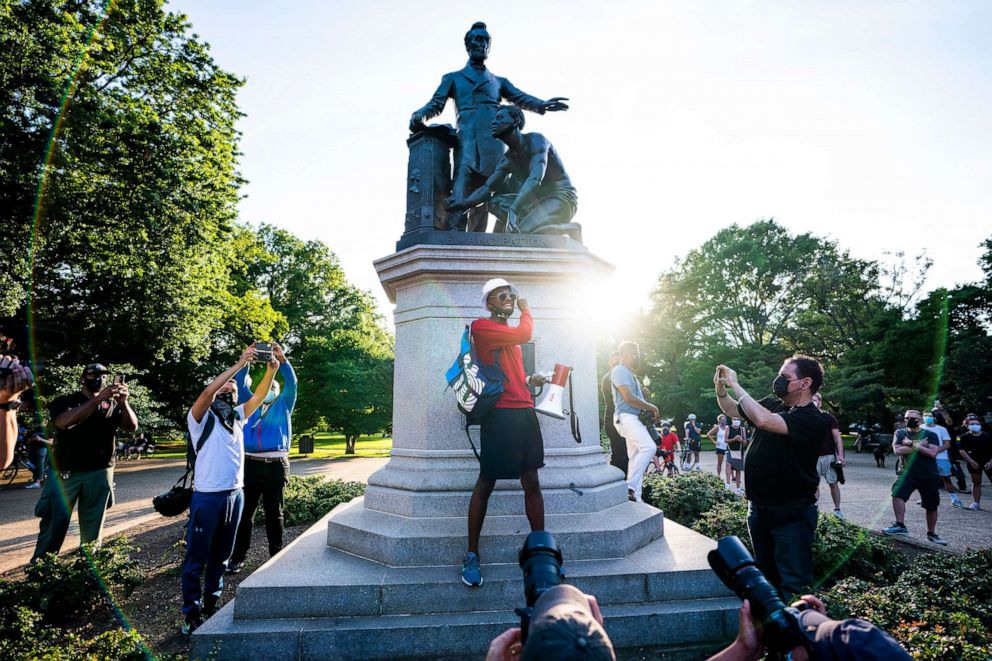 PHOTO: An organizer with the protest group 'The Freedom Neighborhood' announces their plan to tear down a statue depicting Abraham Lincoln standing over a black slave in Washington, June 23, 2020.