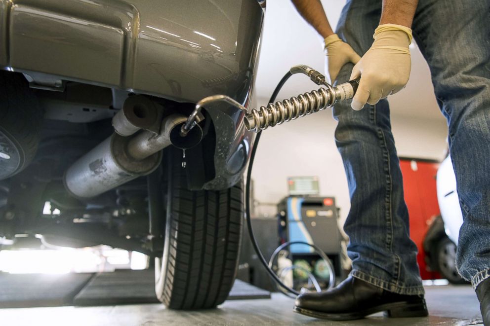 PHOTO: A technician inserts a probe into a tailpipe of a vehicle during a routine smog check in San Francisco, Sept. 27, 2018.