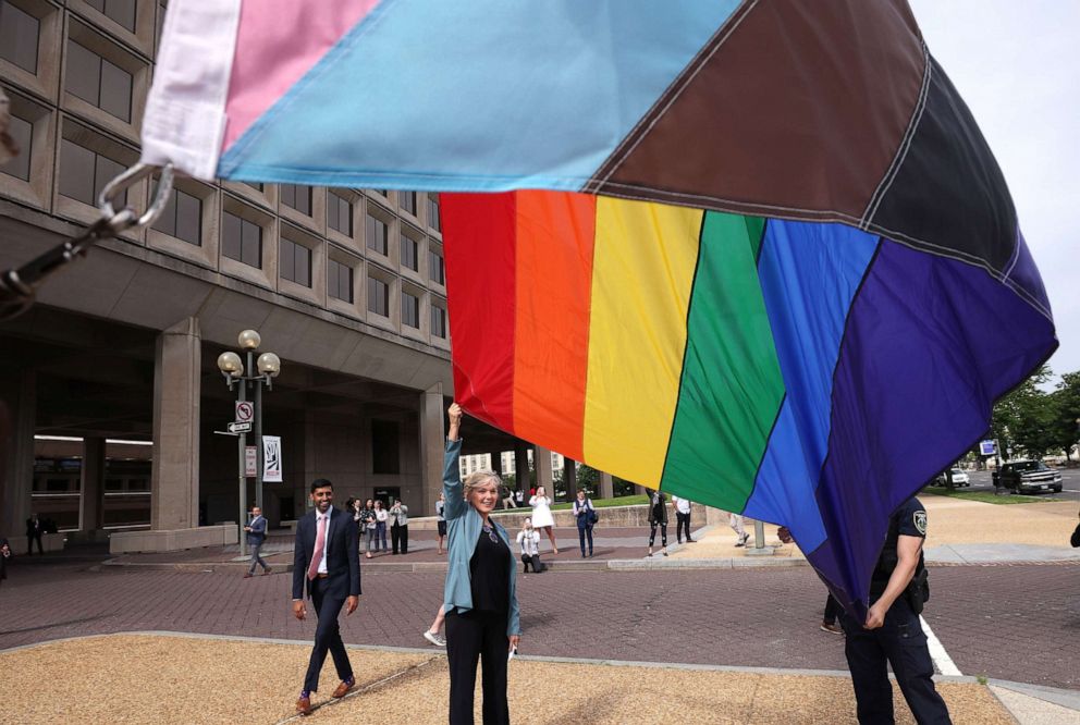 PHOTO: Energy Secretary Jennifer Granholm raises the Progress Pride Flag for the first time, outside the Department of Energy, June 2, 2021, in Washington, D.C., in honor of Pride month.
