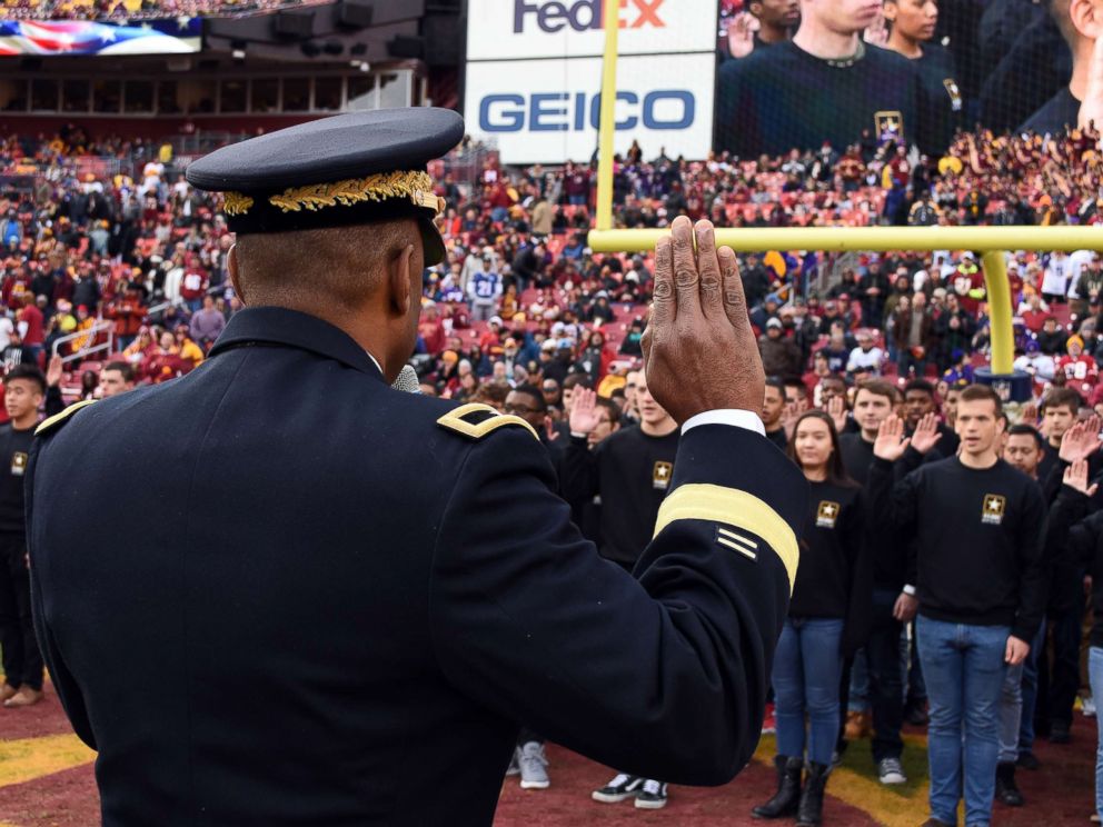 PHOTO: Brig. Gen. Kevin Vereen gives the Oath of Enlistment to nearly 100 people during halftime at a Redskins game at FedEx Field, Nov. 12, 2017.