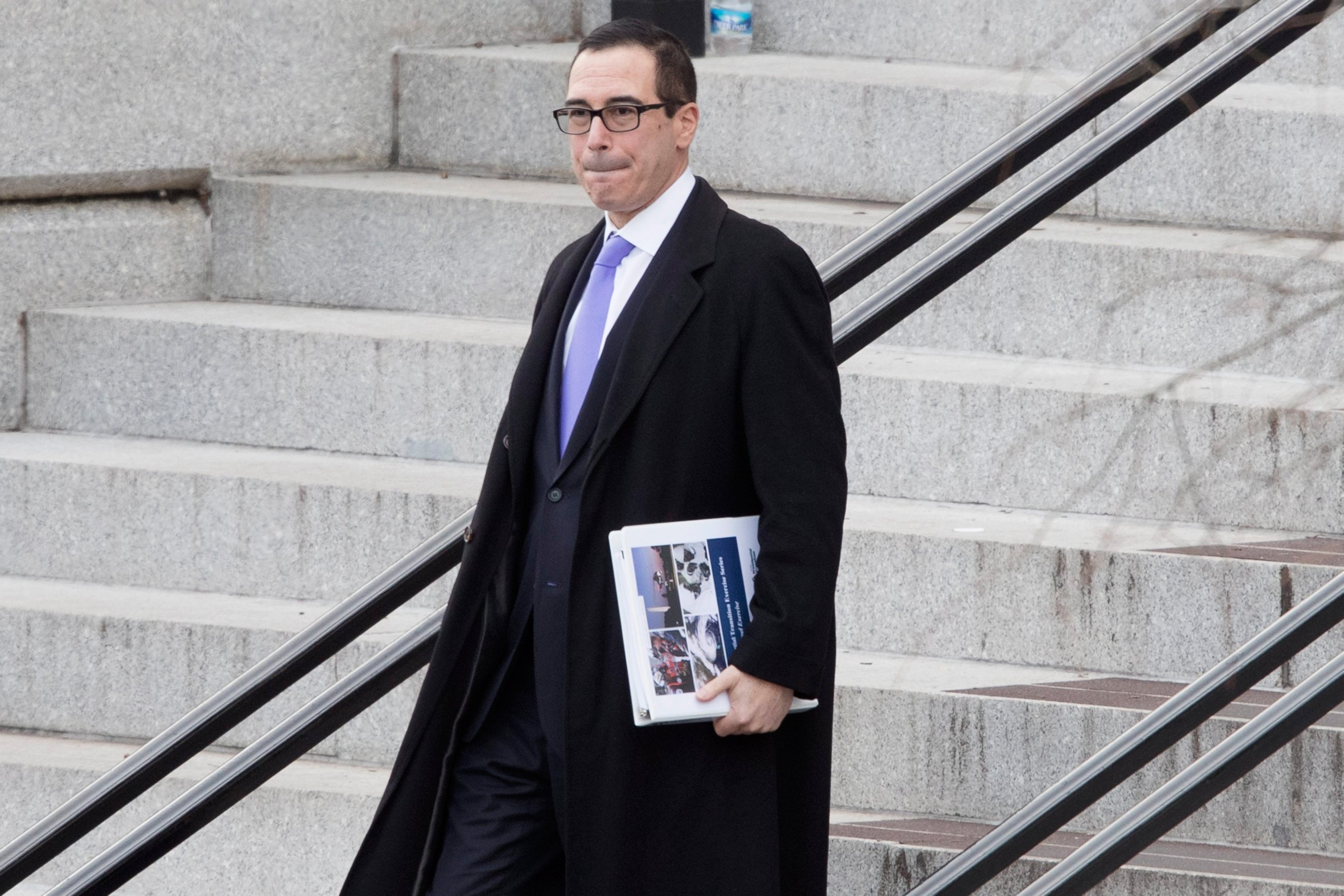 PHOTO: Steve Mnuchin, nominee for Treasury Secretary, walks outside the Eisenhower Executive Office Building after meetings at the White House complex in Washington, Jan. 13, 2017.