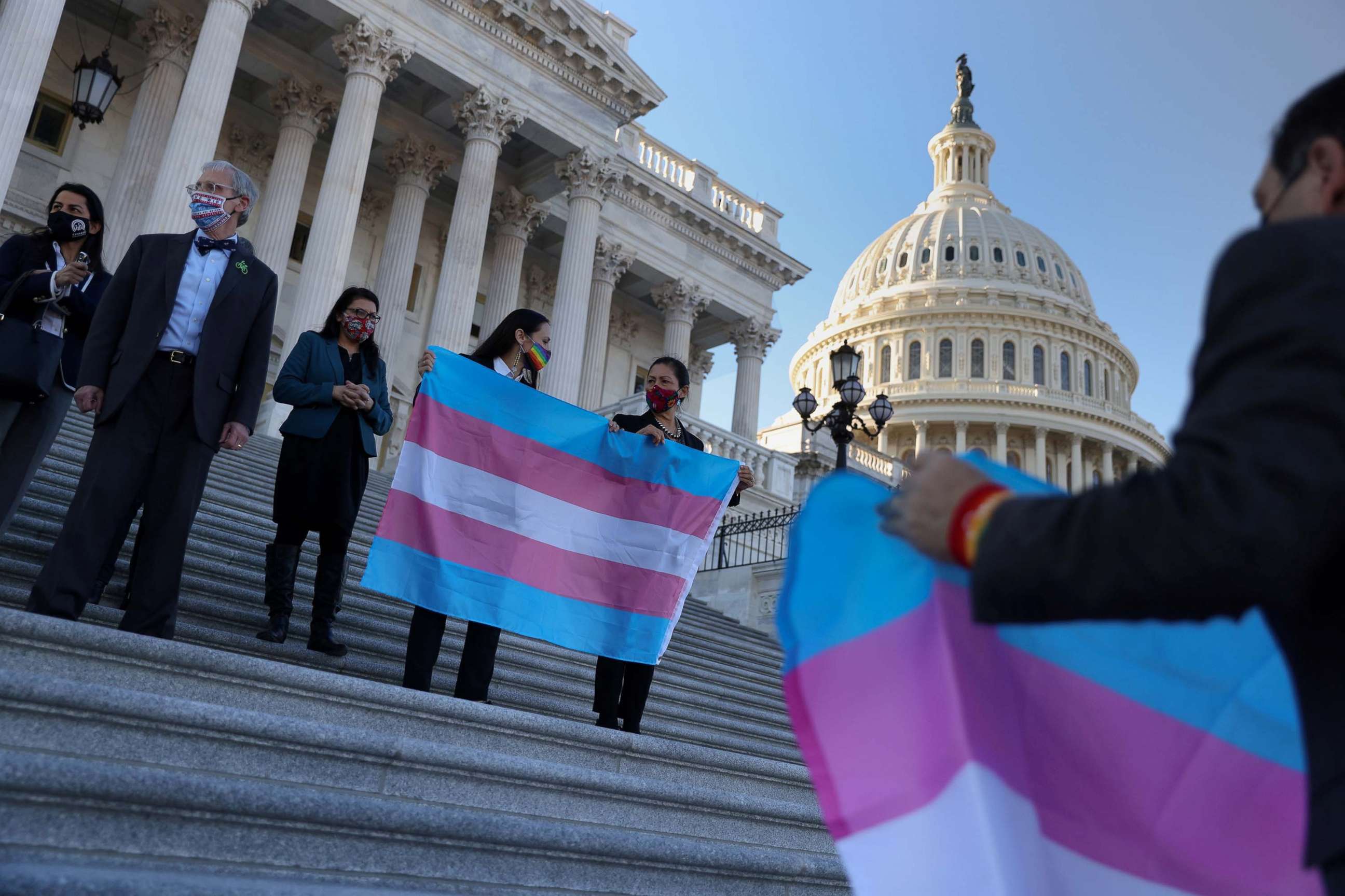 PHOTO: Rep. Deb Haaland holds a Transgender Pride flag beside democratic colleagues on Capitol Hill, Feb. 25, 2021. 