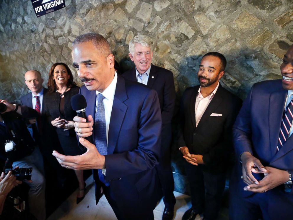 PHOTO: Former Attorney General Eric Holder, center, speaks during a get-out-the-vote event at Blue Bee Cider in Richmond, Va., Oct. 29, 2017.
