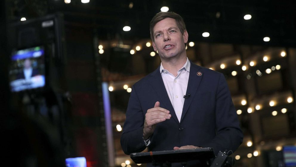 PHOTO: Democratic presidential candidate Rep. Eric Swalwell (D-CA) does a television interview in the spin room before the second night of the first Democratic presidential debate, June 27, 2019, in Miami.