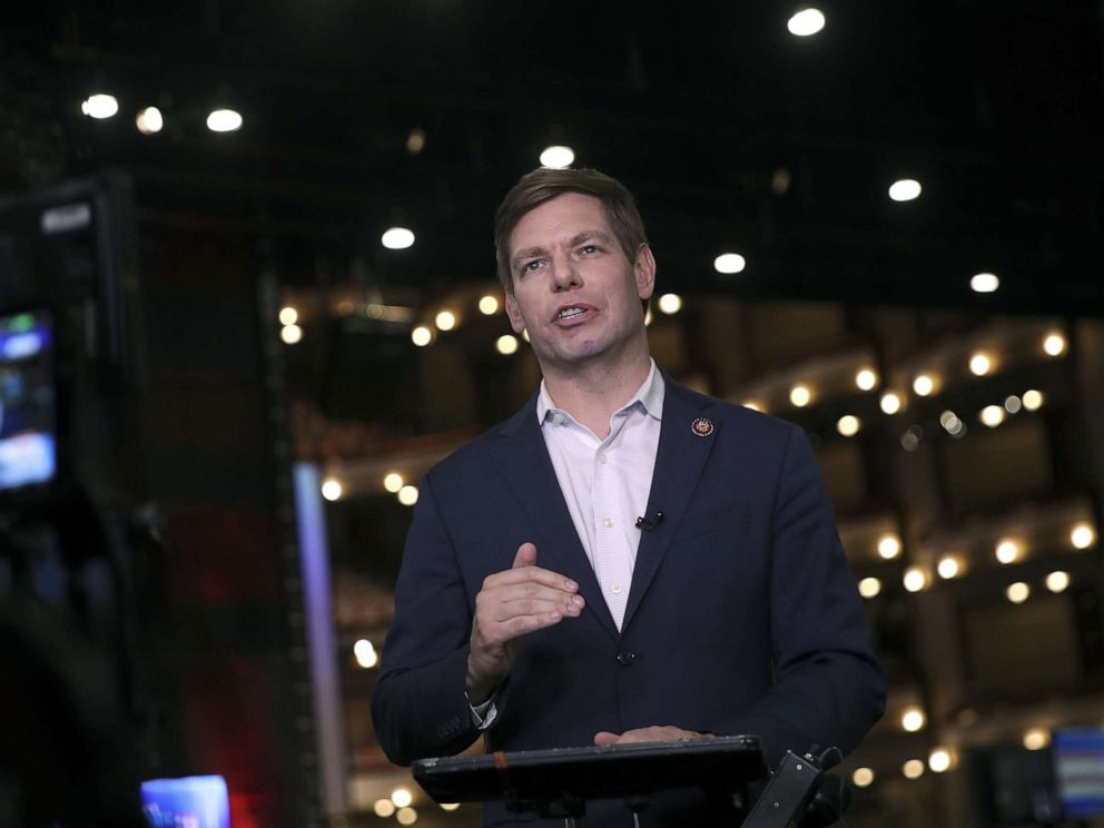 PHOTO: Democratic presidential candidate Rep. Eric Swalwell (D-CA) does a television interview in the spin room before the second night of the first Democratic presidential debate, June 27, 2019, in Miami.