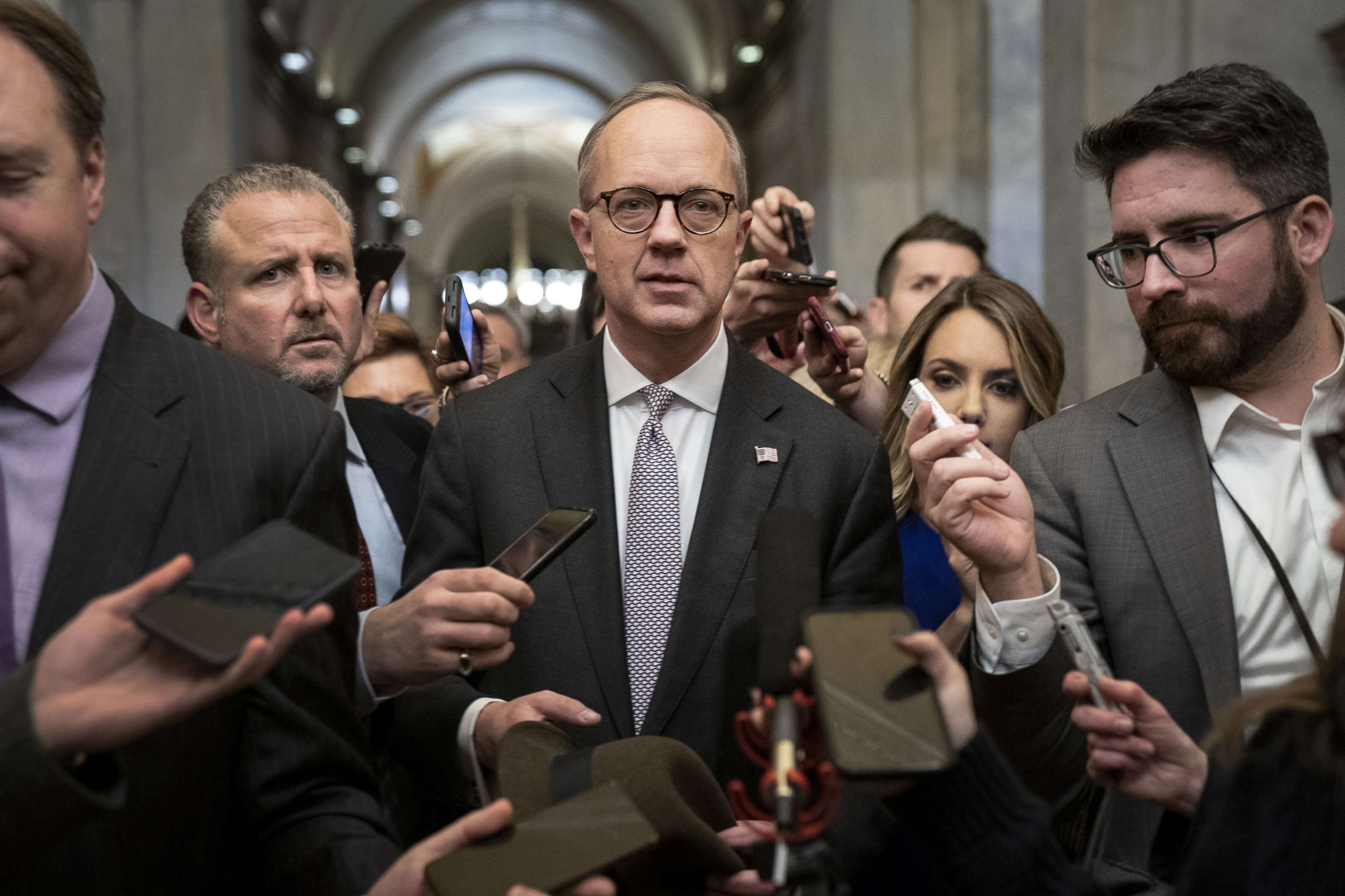 PHOTO: Reporters surround White House Legislative Affairs director Eric Ueland as he  leaves the office of Senate Majority Leader Mitch McConnell, R-KY., after meeting with him at the Capitol in Washington, Dec. 12, 2019.