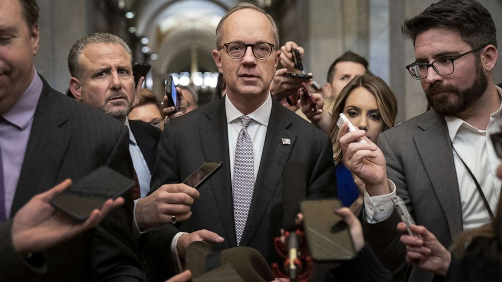 PHOTO: Reporters surround White House Legislative Affairs director Eric Ueland as he  leaves the office of Senate Majority Leader Mitch McConnell, R-KY., after meeting with him at the Capitol in Washington, Dec. 12, 2019.