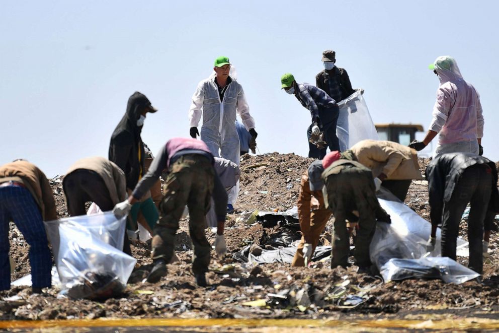 PHOTO: People work to search for belongings and debris for forensic analysis at the  crash site of the Ethiopian Airlines operated Boeing 737 MAX aircraft in Ethiopia, March 15, 2019.