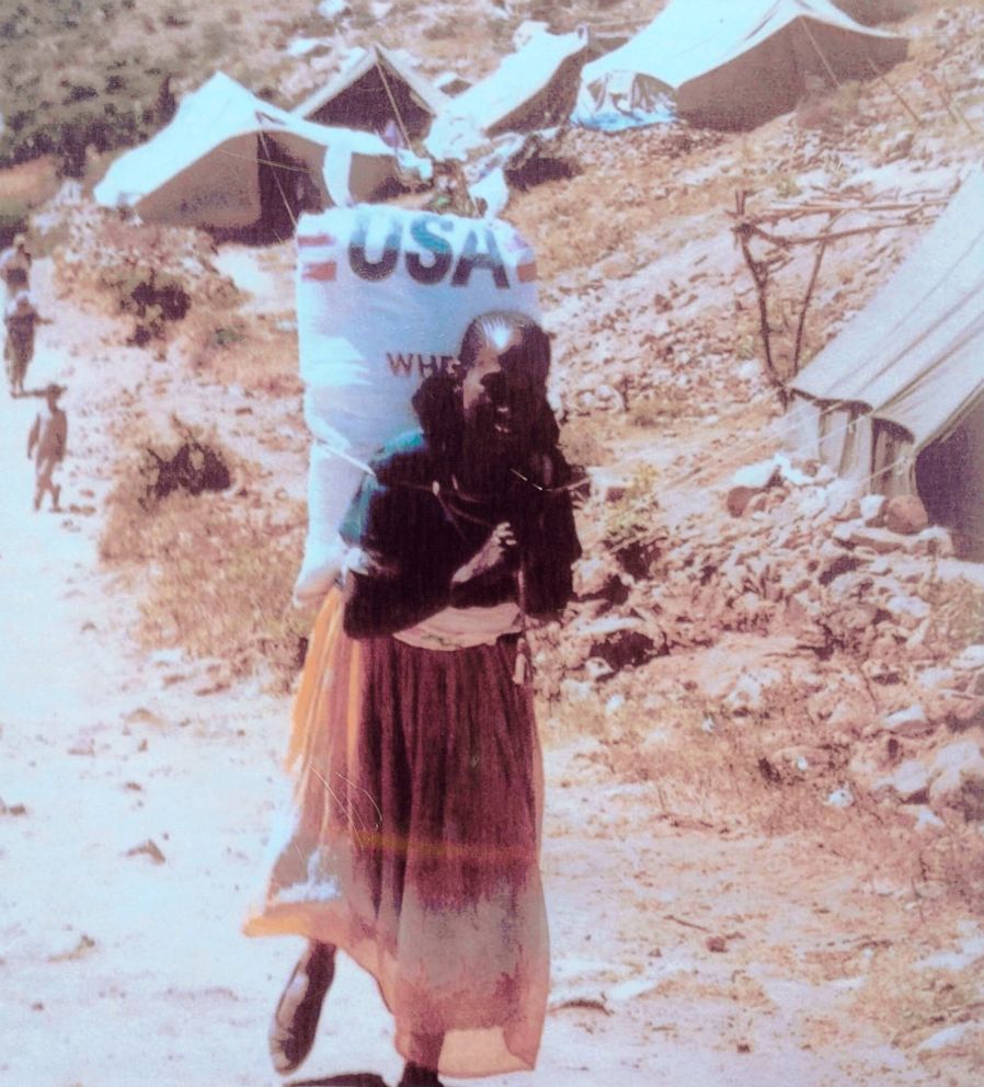 PHOTO: Photo taken by Patti Garamendi of a woman carrying 110-pound bag of grain.