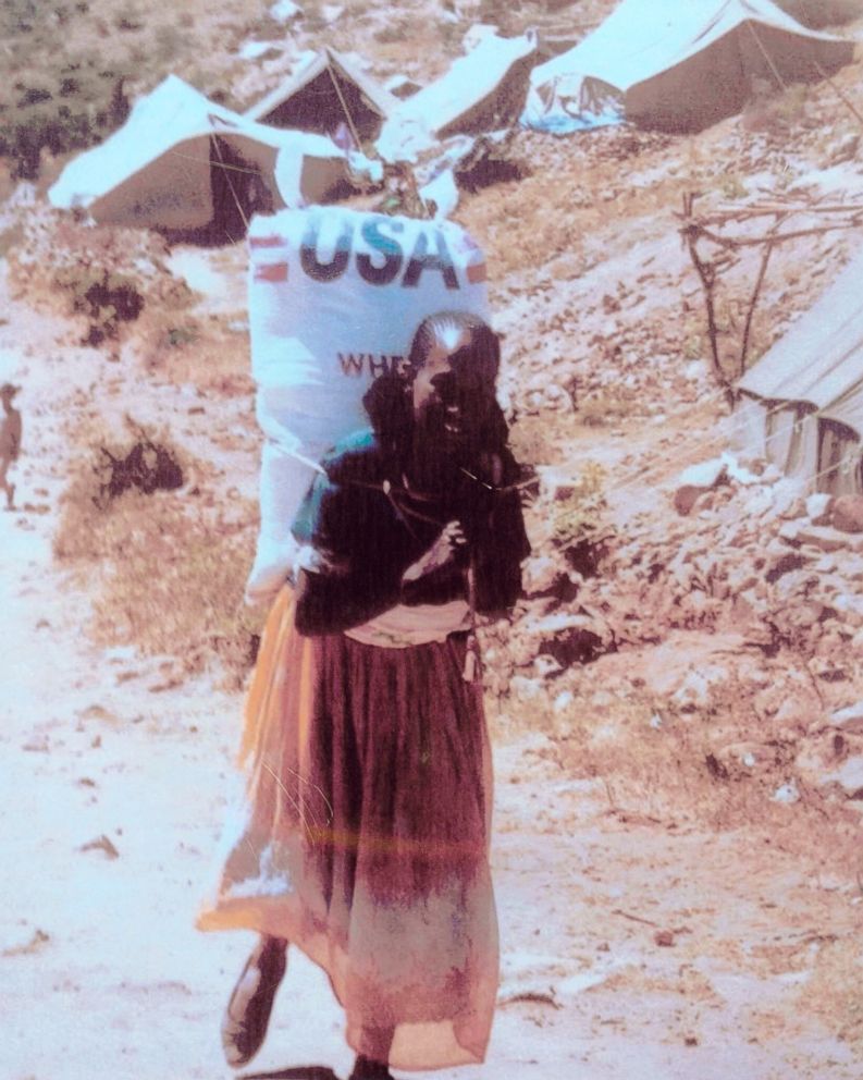 PHOTO: Photo taken by Patti Garamendi of a woman carrying 110-pound bag of grain.