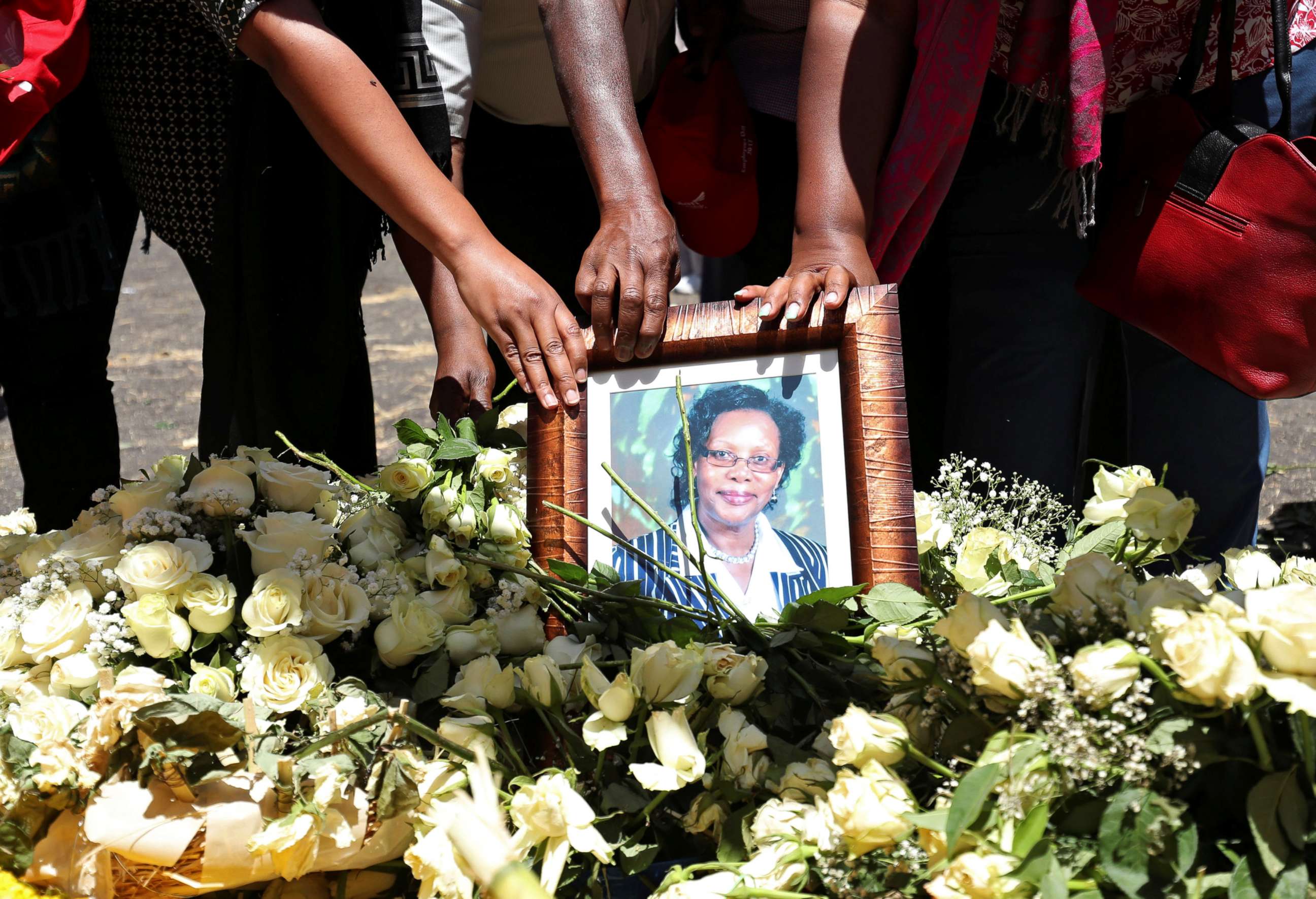 PHOTO: United Nations workers hold a portrait as they mourn their colleagues during a commemoration ceremony for the victims at the scene of the Ethiopian Airlines Flight ET 302 plane crash, near Addis Ababa, Ethiopia March 15, 2019.