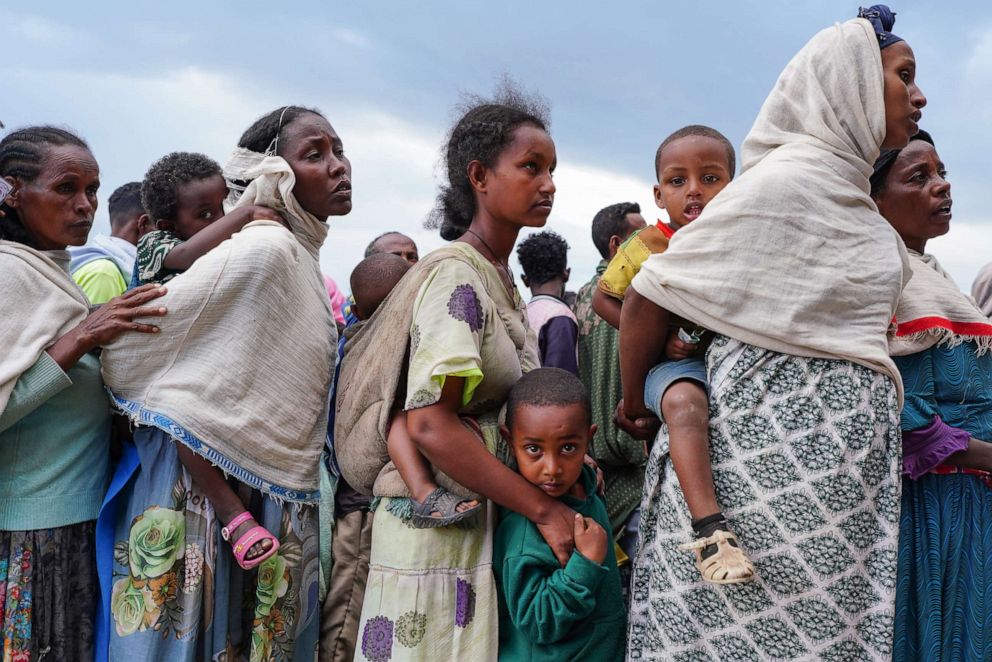 PHOTO: Internally displaced people wait to retrieve Food Aid being distributed by the Amhara Emergency Fund at the Millennium School on Oct. 10, 2021, in Debark, Ethiopia.