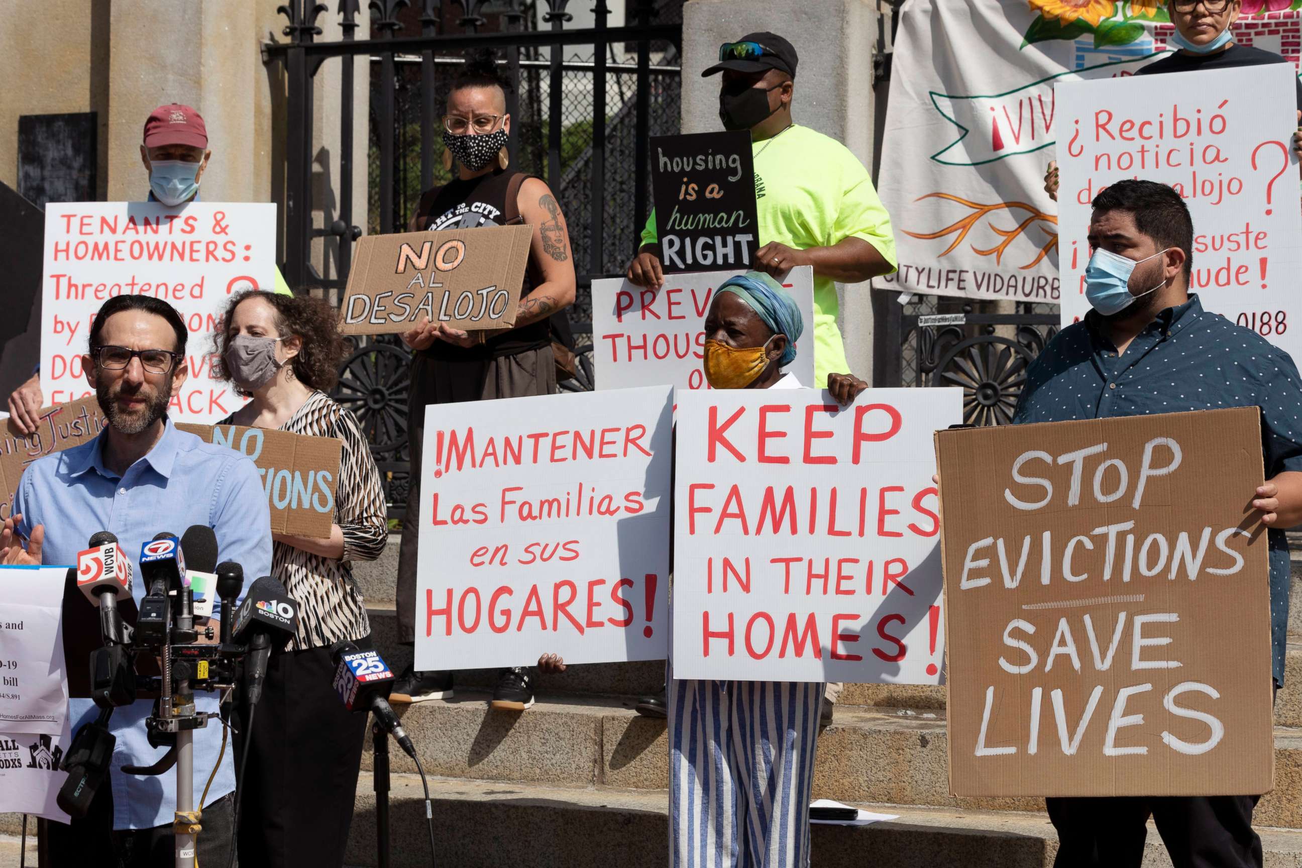 PHOTO: People from a coalition of housing justice groups hold signs protesting evictions during a news conference outside the Statehouse, Friday, July 30, 2021, in Boston.
