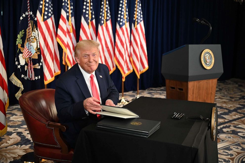 PHOTO: President Donald Trump signs executive actions extending coronavirus economic relief, during a news conference in Bedminster, N.J., on Aug. 8, 2020.