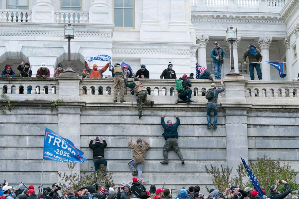 PHOTO: Supporters of President Donald Trump climb the west wall of the the U.S. Capitol, Jan. 6, 2021. 