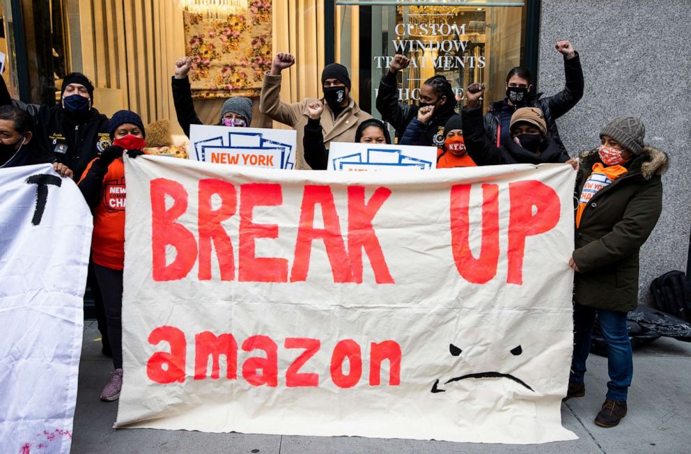 PHOTO:Demonstrators hold signs during a protest outside the home of Amazon Chief Executive Officer Jeff Bezos in New York, Dec. 2, 2020.