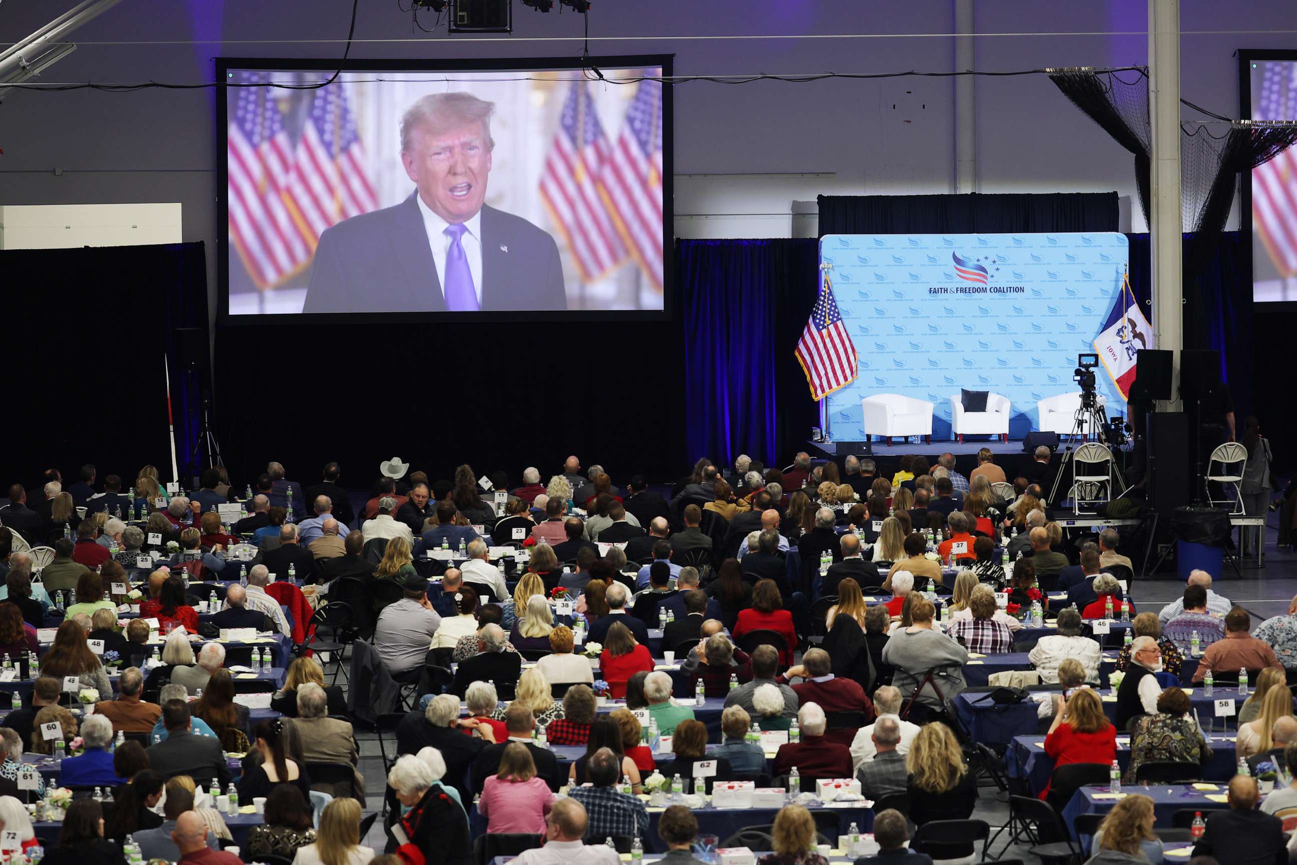 PHOTO: Former President Donald Trump speaks to guests via video link at the Iowa Faith & Freedom Coalition Spring Kick-Off on April 22, 2023 in Clive, Iowa.