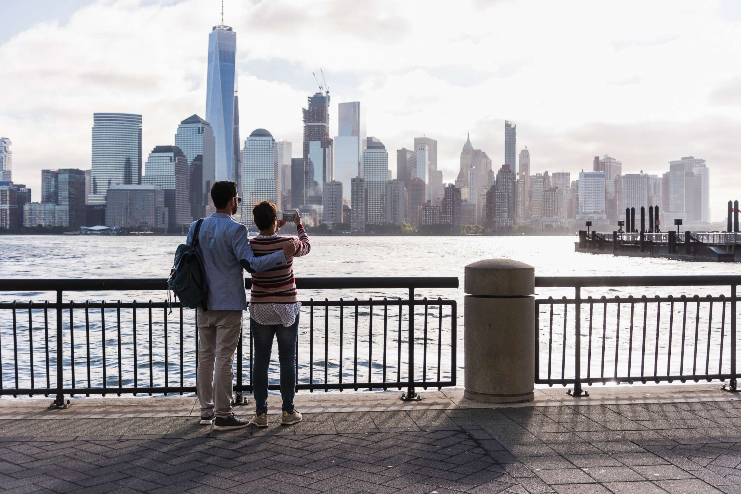 PHOTO: A couple stands looking at Manhattan. 