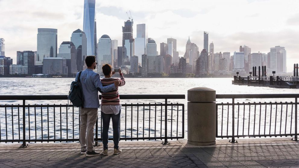 PHOTO: A couple stands looking at Manhattan. 