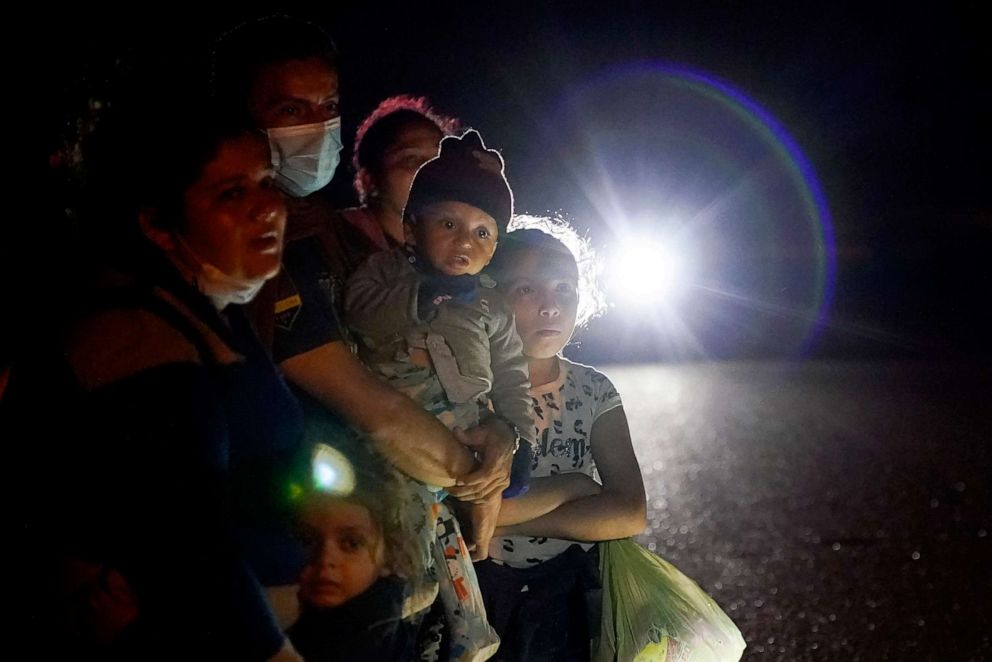PHOTO: A group of migrants mainly from Honduras and Nicaragua wait along a road after turning themselves in upon crossing the U.S.-Mexico border, in La Joya, Texas, May 17, 2021.