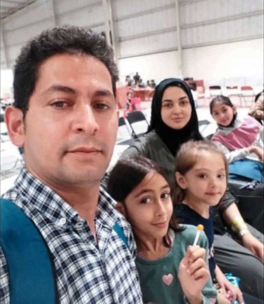 PHOTO:  Abdul, his wife Lima, and their three daughters wait at a U.S. military base in the UAE after escaping Kabul as part of the unprecedented evacuation operation.