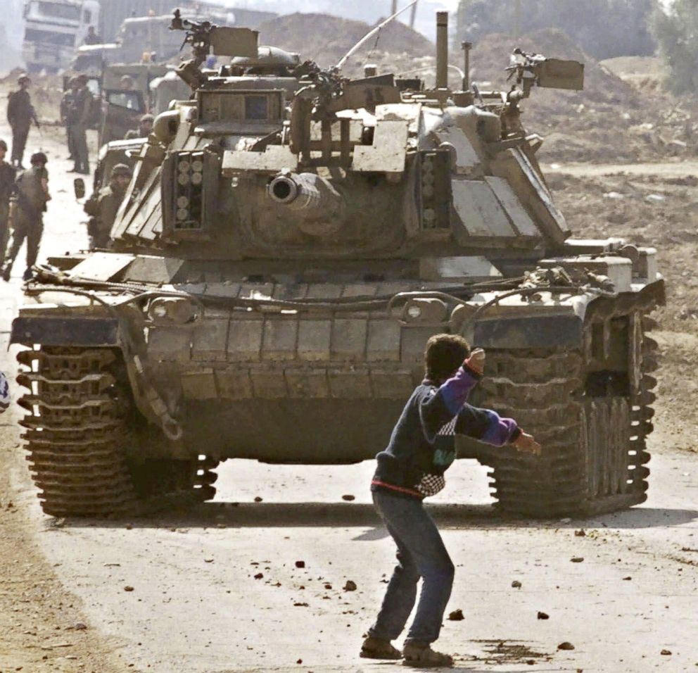 PHOTO: A Palestinian stone thrower faces an Israeli tank, during clashes at the Karni crossing point between Israel and the Gaza Strip, on the outskirts of Gaza City, in this Oct. 29, 2000 file photo.